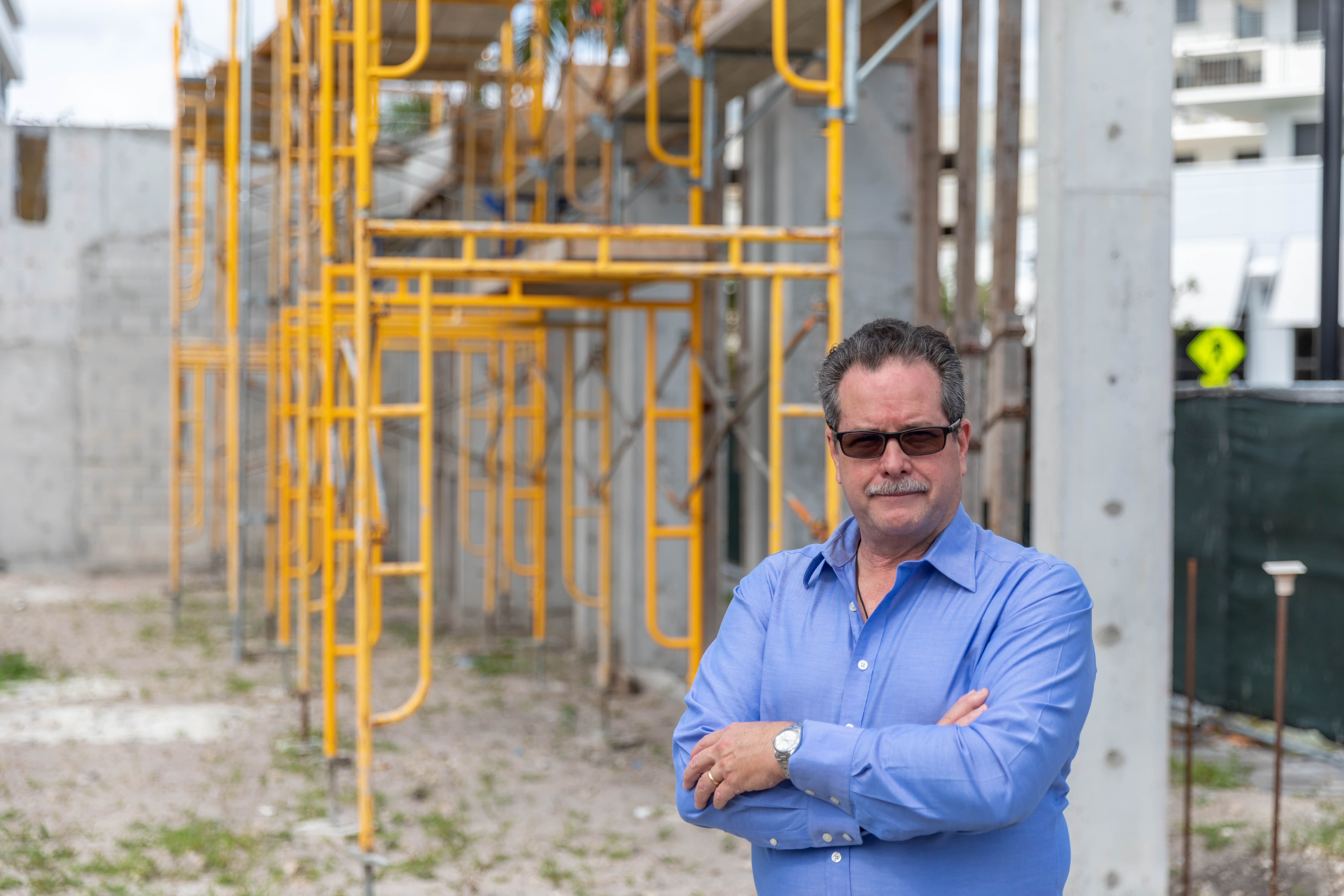 Founder of MAC Risk Services in front of construction